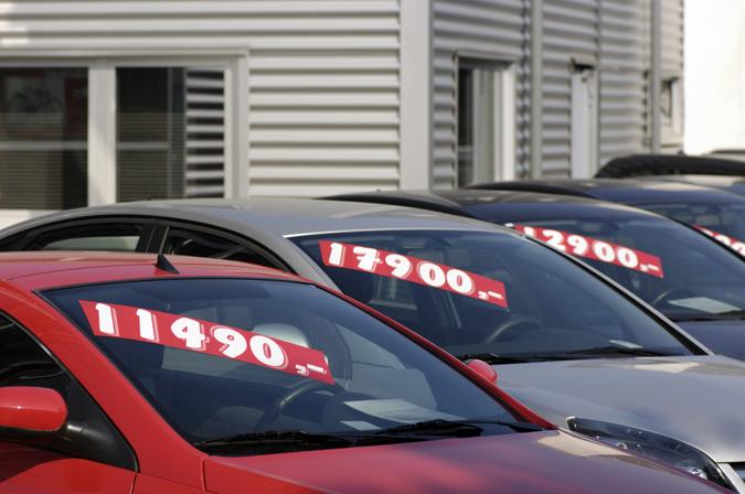 Row of used car with prices.