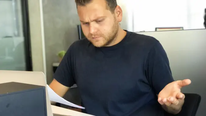 A angry man in bad financial situation stress at office stock photo