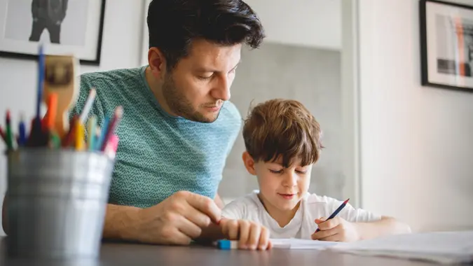 Father and Son doing homework Together stock photo