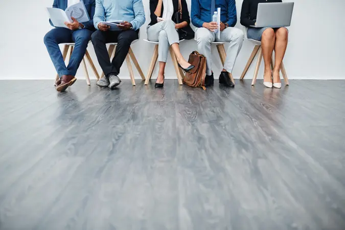 Cropped studio shot of a group of diverse businesspeople waiting in line.