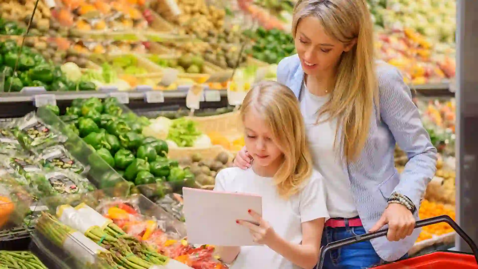 Mother and daughter shopping vegetables groceries store.