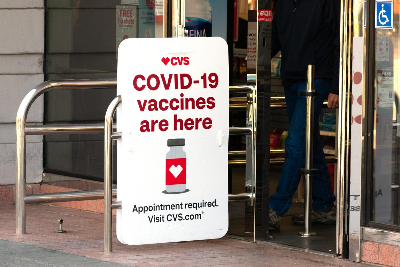 Covid-19 vaccines are here sign advertises coronavirus vaccination location at CVS Pharmacy store.