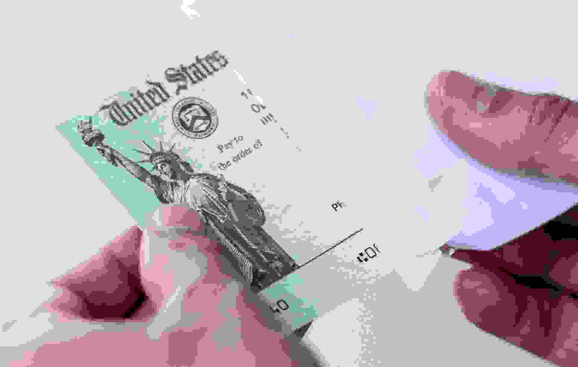 Men hands holding a US Government Treasury check.