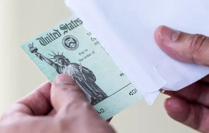 Men hands holding a US Government Treasury check.