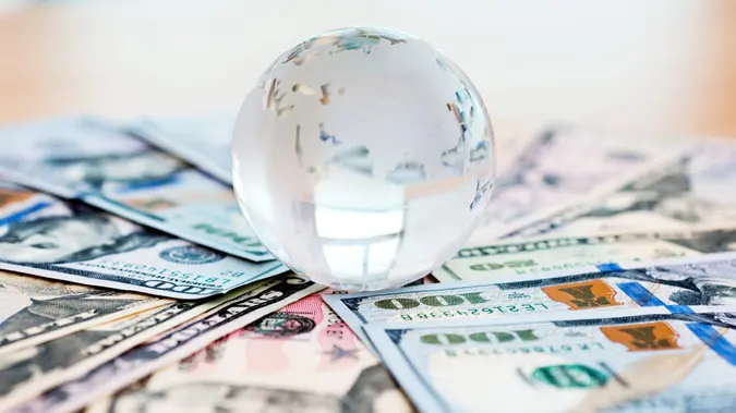 Glass globe and US dollar bills.