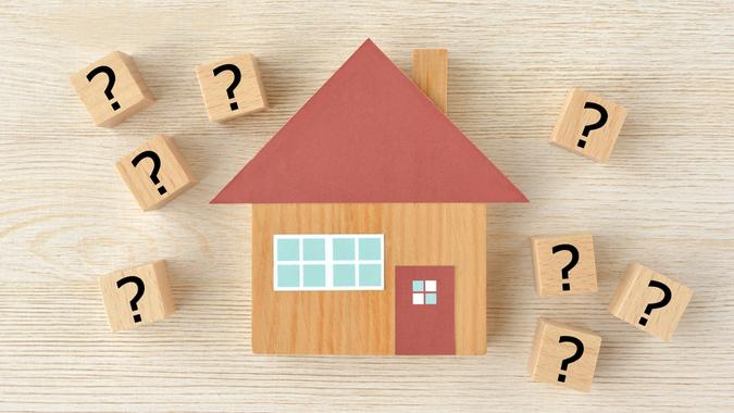 House object and wooden blocks with question mark stock photo