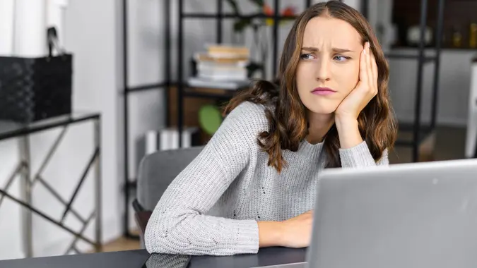 Bored female office employee with a laptop stock photo