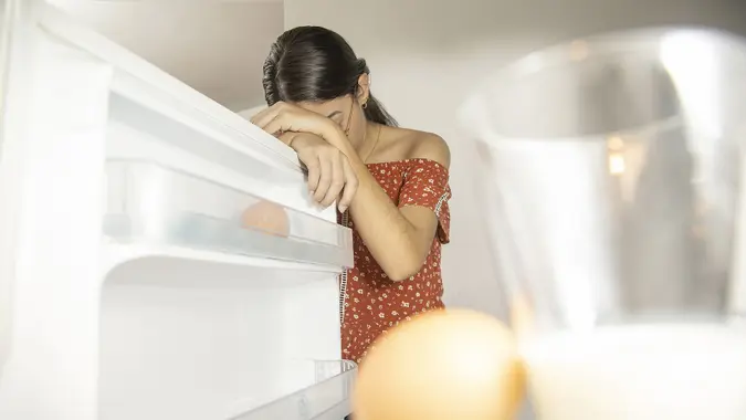 Woman worried about food shortage, post pandemic concept stock photo