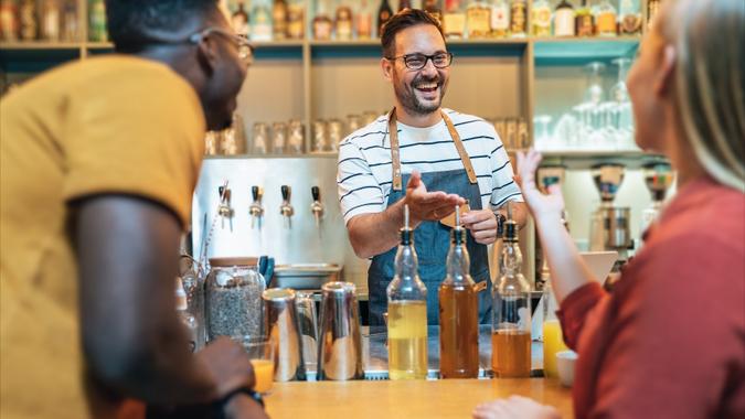 Bartender with customers stock photo