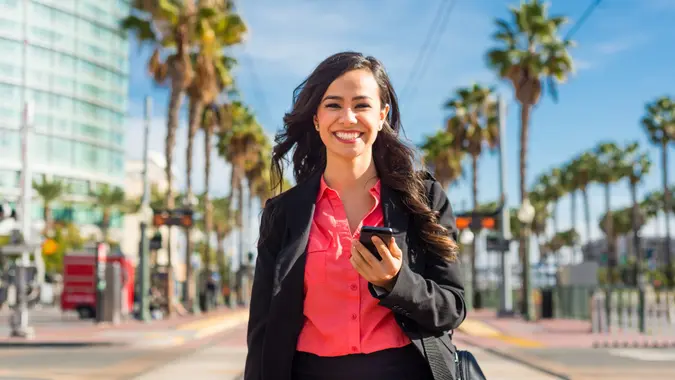 Business woman walking and smiling