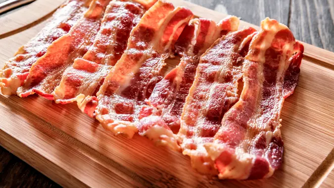 Roasted bacon on cutting board.