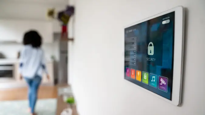 Close-up on a tablet computer on the wall used to control a smart home - technology concepts.
