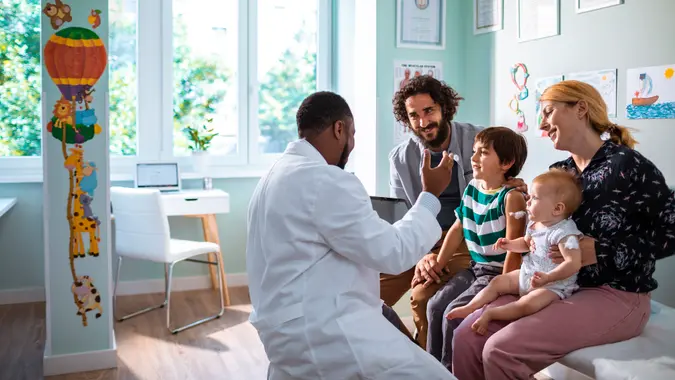 Close up of a young family at a Pediatrician's Office.