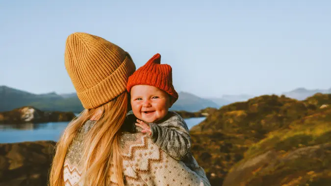 Cute baby and mother walking outdoor travel family vacations lifestyle mom and smiling child together Mothers day holiday.