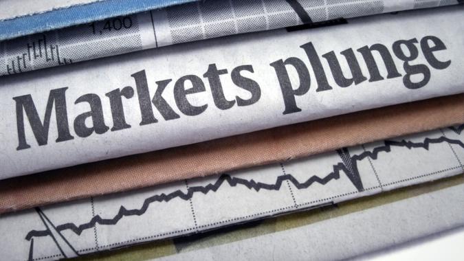 Newspaper headline "Markets plunge".