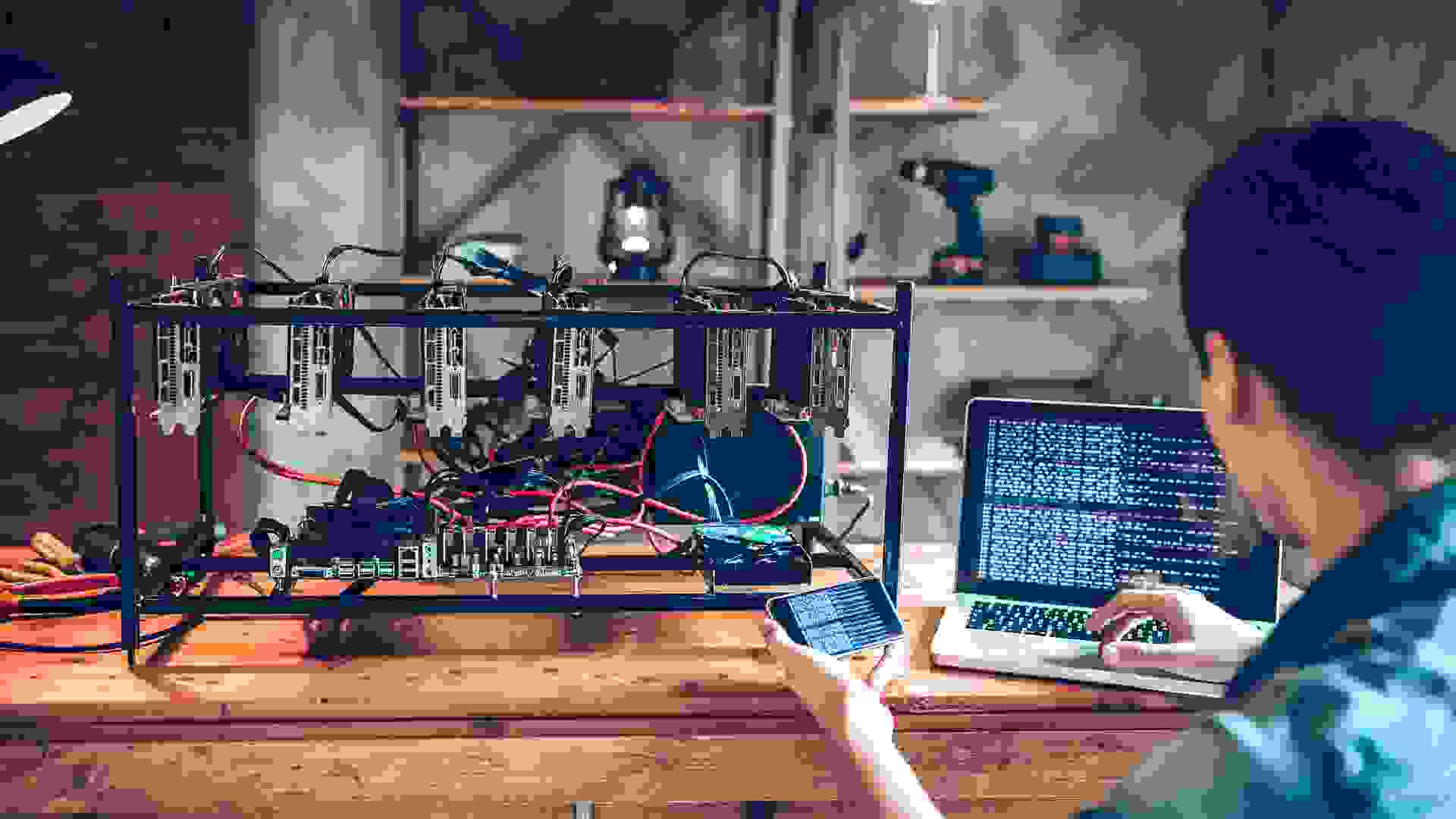 Programmer preparing mining rig with GPU.