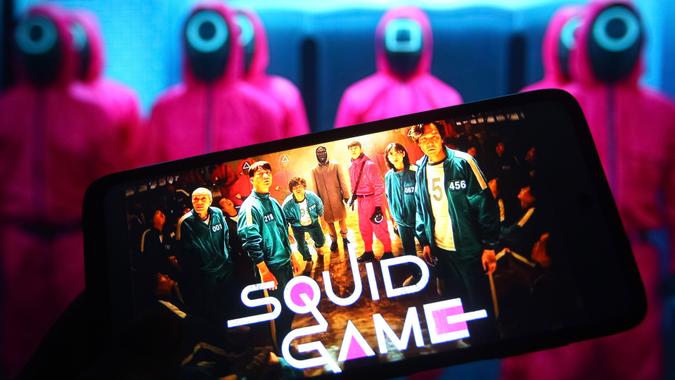 Mandatory Credit: Photo by Pavlo Gonchar/SOPA Images/Shutterstock (12531541t)In this photo illustration a Squid Game television series logo streaming on Netflix is seen on a smartphone.
