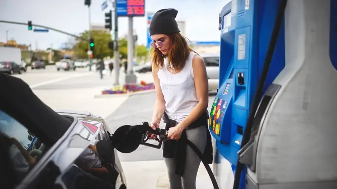 Woman at the gas station stock photo