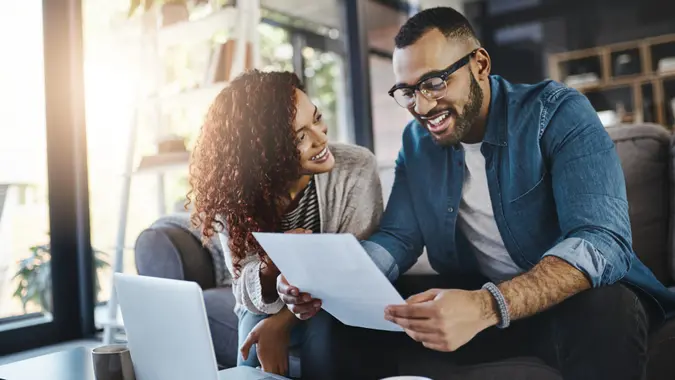 Shot of a young couple planning their budget together at home.