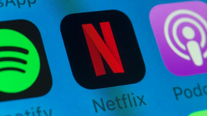 London, UK - August 01, 2018: The buttons of Netflix, Spotify, Podcasts, WhatsApp and Music on the screen of an iPhone.