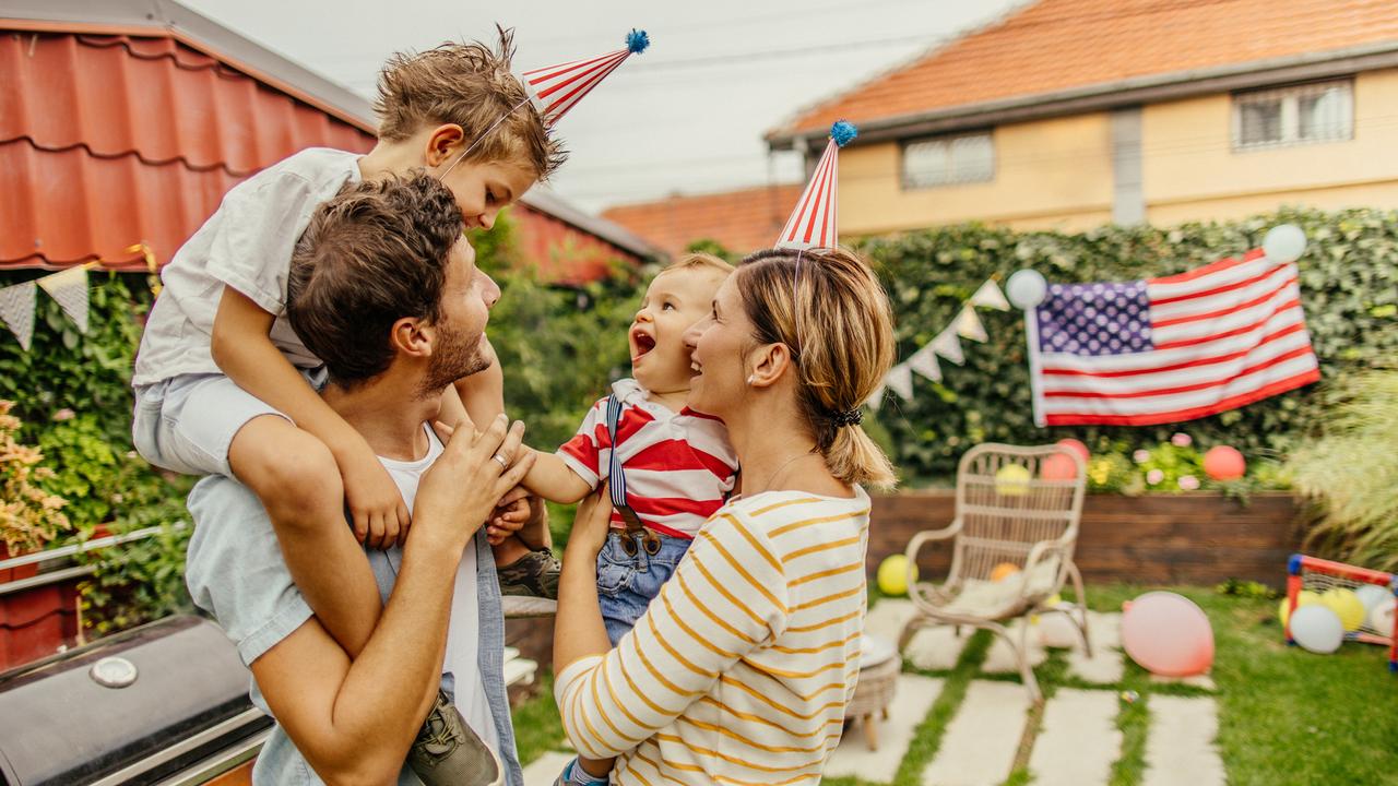 Photo of a happy family celebrating Fourth of July in their yard.