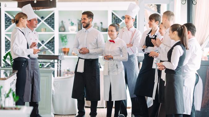 Restaurant manager and his staff in terrace.