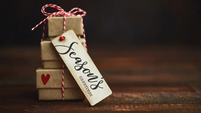Tiny gift stack with heart decoration and Christmas Greeting.