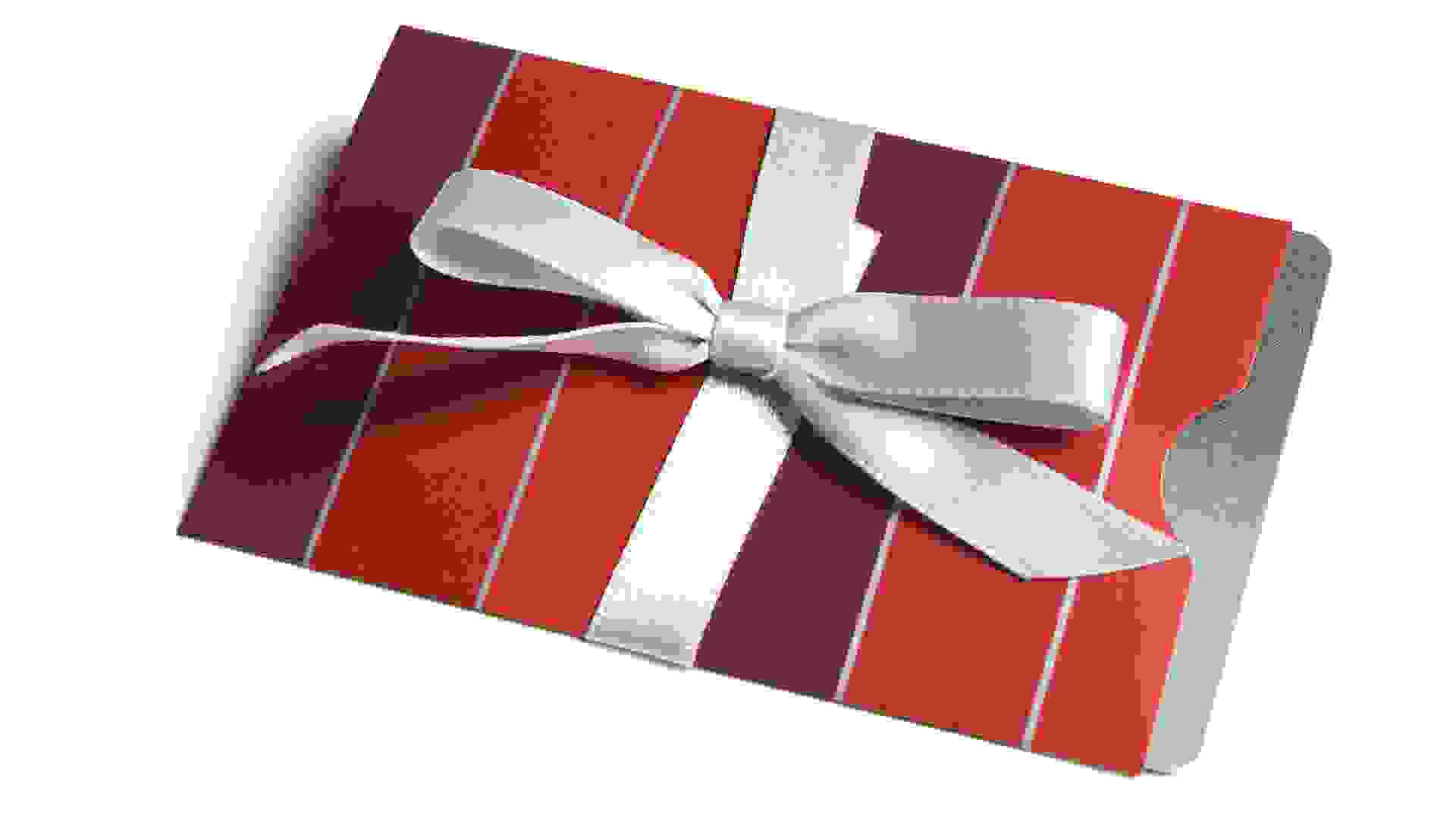 A gift card in a striped envelope tied with a bow - isolated.