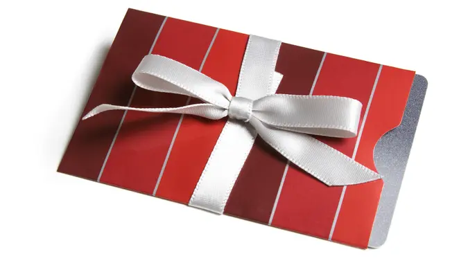 A gift card in a striped envelope tied with a bow - isolated.