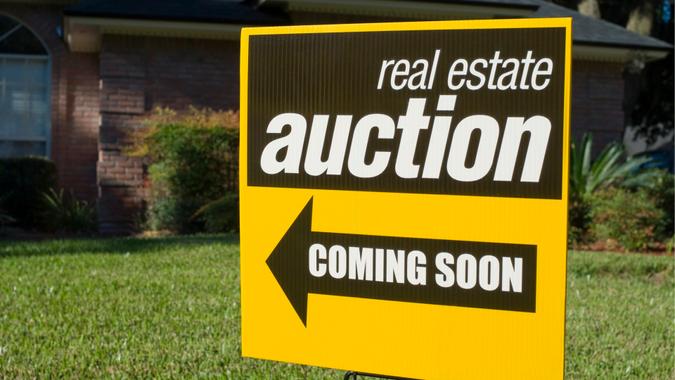 Real Estate Auction sign in a front yard.