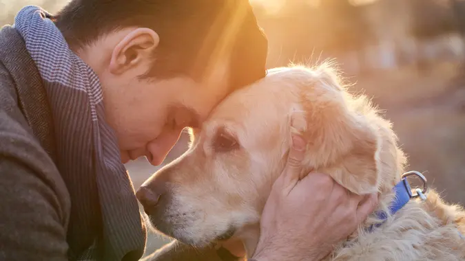 Man embracing his faithful friend the dog.