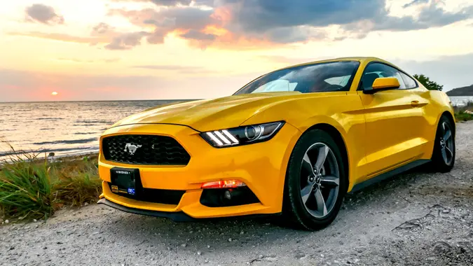 Campeche, Mexico - May 20, 2017: Yellow muscle car Ford Mustang at the countryside.