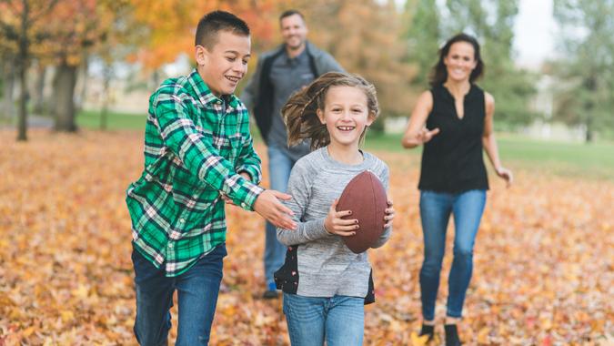 A young girl races toward the camera with a big grin and.