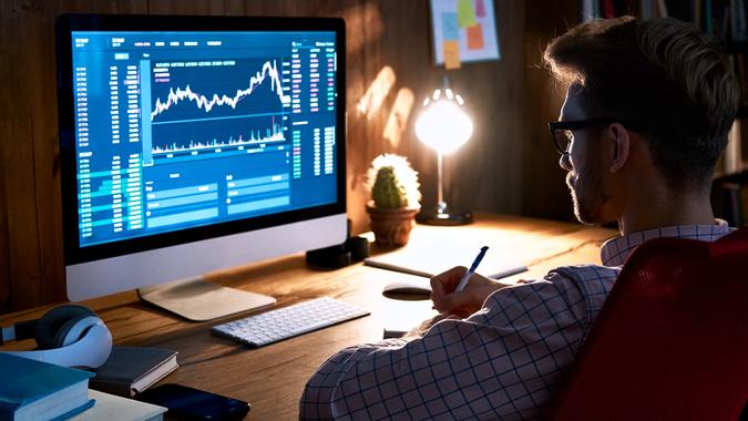 Business man stock exchange trader broker looking at pc computer screen, investor manager analyzing financial chart trading online investment data price crypto currency market graph, managing risks. stock photo
