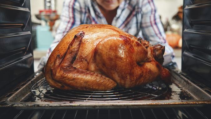 Roasting Turkey in the Oven for Holiday Dinner stock photo