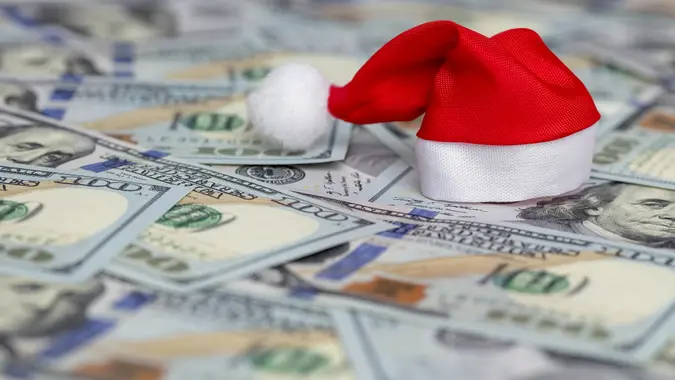 Santa hat on heap of US dollars stock photo