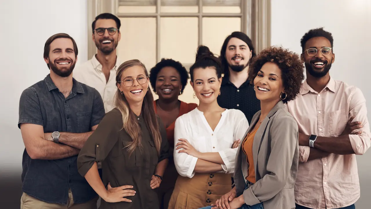 Portrait of a group of businesspeople standing together in an office.