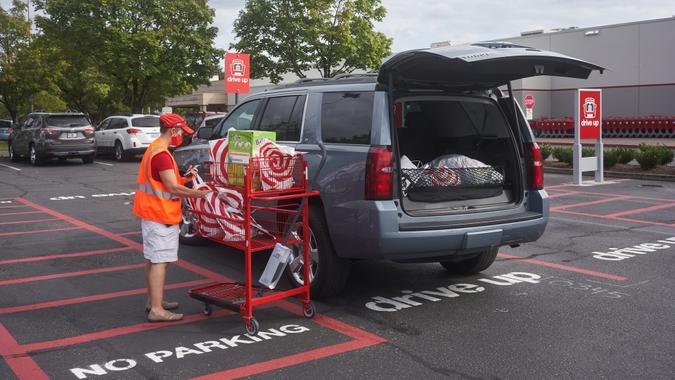 Tigard, OR, USA - Sep 19, 2020: A Target store employee brings bagged items out to a customer's car parked in the drive-up area outside the Target Tigard store during the coronavirus pandemic.