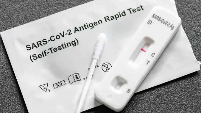 Negative Covid-19 antigen test kit, one step coronavirus antigen rapid test, saliva swab, 1 test box with imagine of lungs, close up.