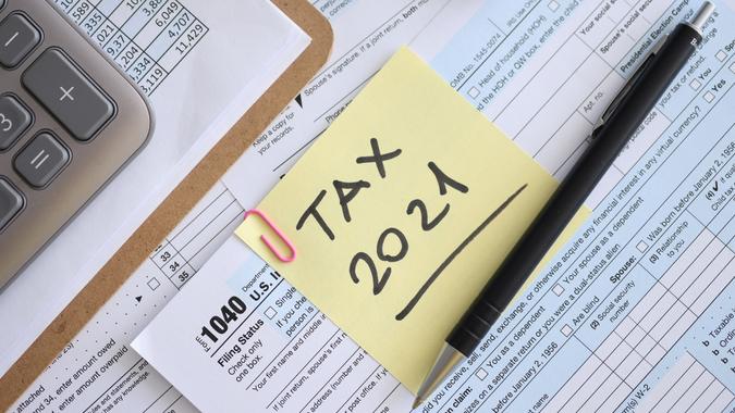 Tax form for 2021 with pen and report is on table stock photo