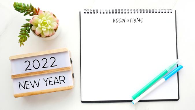2022 new year on wood box, Resolution on blank notebook paper on white background, 2022 new year mock up, template, flat lay.