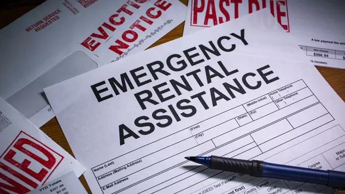 A blank application for Emergency Rental Assistance is on a desktop.