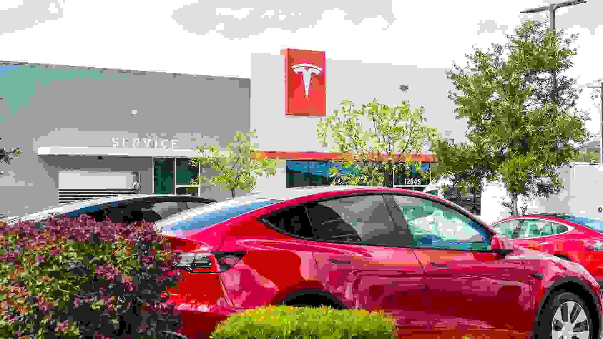 Austin, TX, USA - September 14, 2020: Red Tesla Model Y in front of Telsa Building in the northwest Pond Springs Dealer Location for Tesla.