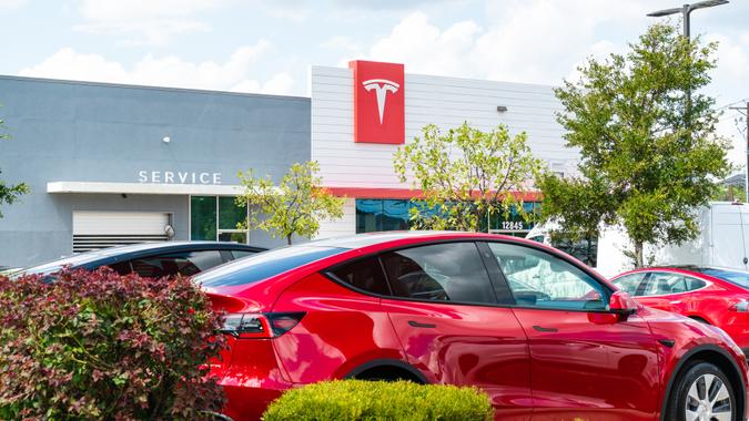 Austin, TX, USA - September 14, 2020: Red Tesla Model Y in front of Telsa Building in the northwest Pond Springs Dealer Location for Tesla.