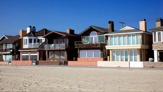 View from beach of houses owned and for rent as vacation spots on front of beach views in Newport Beach, California Orange County.