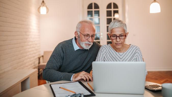 Time to go over the budget Senior couple browsing the internet together.