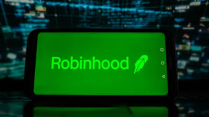 Mandatory Credit: Photo by Omar Marques/SOPA Images/Shutterstock (12769993l)In this photo illustration, a Robinhood logo is displayed on a smartphone with stock market percentages in the background.