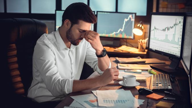 Depressed frustrated trader tired of overwork or stressed by bankruptcy stock photo