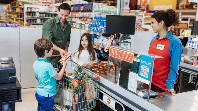 Family with children in supermarket stock photo