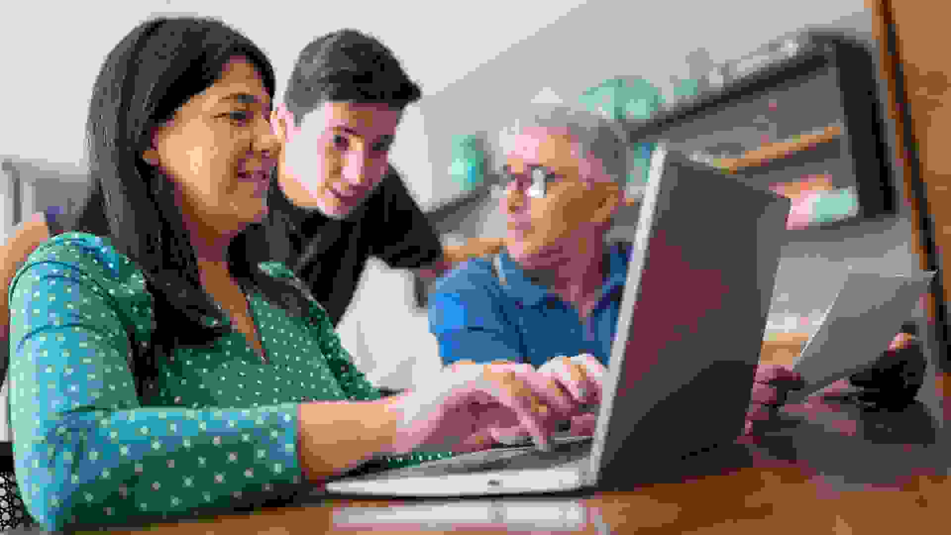 Parents doing home finances and talking to teenager son stock photo